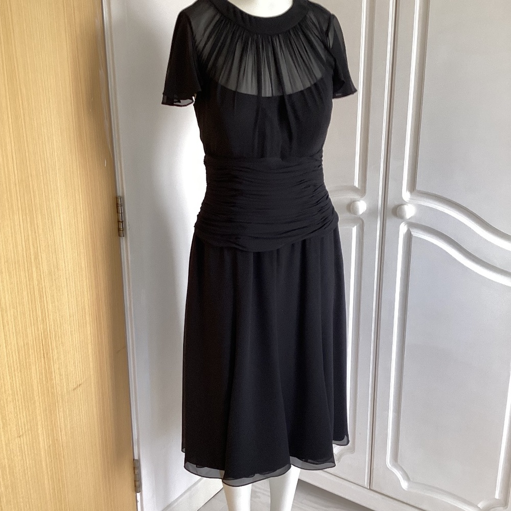 Belinda ch’ng.     Ladies black dress